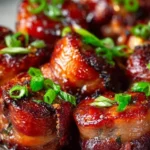 Delicious bacon wrapped barbecue beef bites on a serving platter