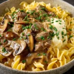 Delicious beef stroganoff served over pasta with a creamy sauce.