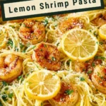 Plate of Lemon Shrimp Pasta garnished with herbs and lemon slices