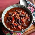 Bowl of Black Bean and Ham Soup garnished with cilantro.