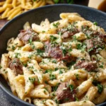 Creamy Italian Beef Pasta Bake topped with cheese and herbs in a baking dish.