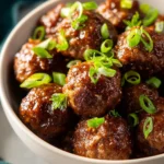 Delicious honey garlic meatballs served on a plate with garnish.