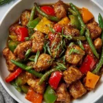 Delicious Hunan chicken dish served with vegetables and spicy sauce