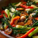 Bowl of colorful saucy vegetable stir fry with fresh ingredients and vibrant colors