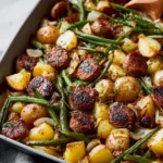 Savory sausage bake with green beans and potatoes in a baking dish