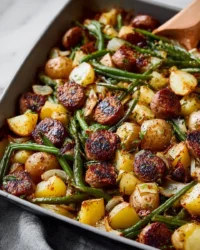Savory sausage bake with green beans and potatoes in a baking dish