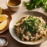 Slow Cooker Lemon Garlic Chicken served with herbs and lemon slices