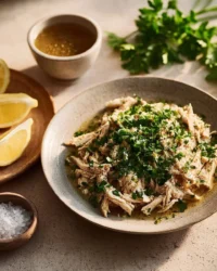 Slow Cooker Lemon Garlic Chicken served with herbs and lemon slices