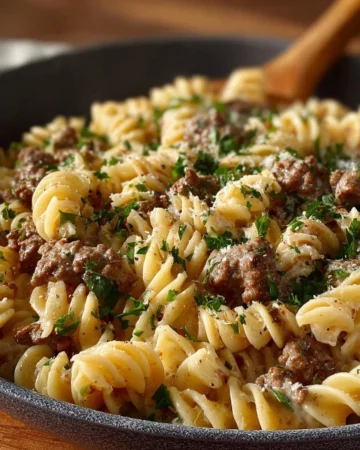 Delicious ground beef stroganoff served with noodles and garnished with parsley