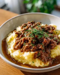 Delicious homemade beef gravy poured over tender meat and mashed potatoes.