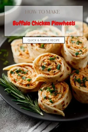 Buffalo chicken pinwheels served on a plate, garnished with fresh herbs.