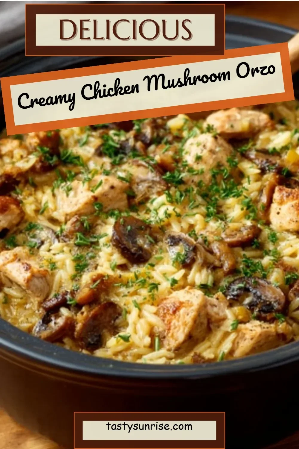 Creamy chicken mushroom orzo in a bowl, garnished with herbs.