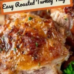 Juicy roasted turkey thighs garnished with herbs on a serving platter