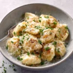 A bowl of creamy Easy Tortellini Alfredo topped with parsley