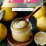 Jar of homemade lemon curd with fresh lemons and a whisk