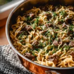 Delicious quick beef stroganoff served with noodles and garnished with parsley