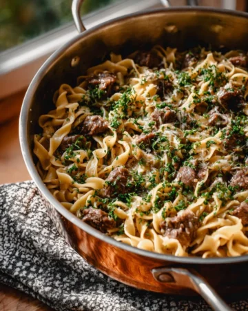 Delicious quick beef stroganoff served with noodles and garnished with parsley