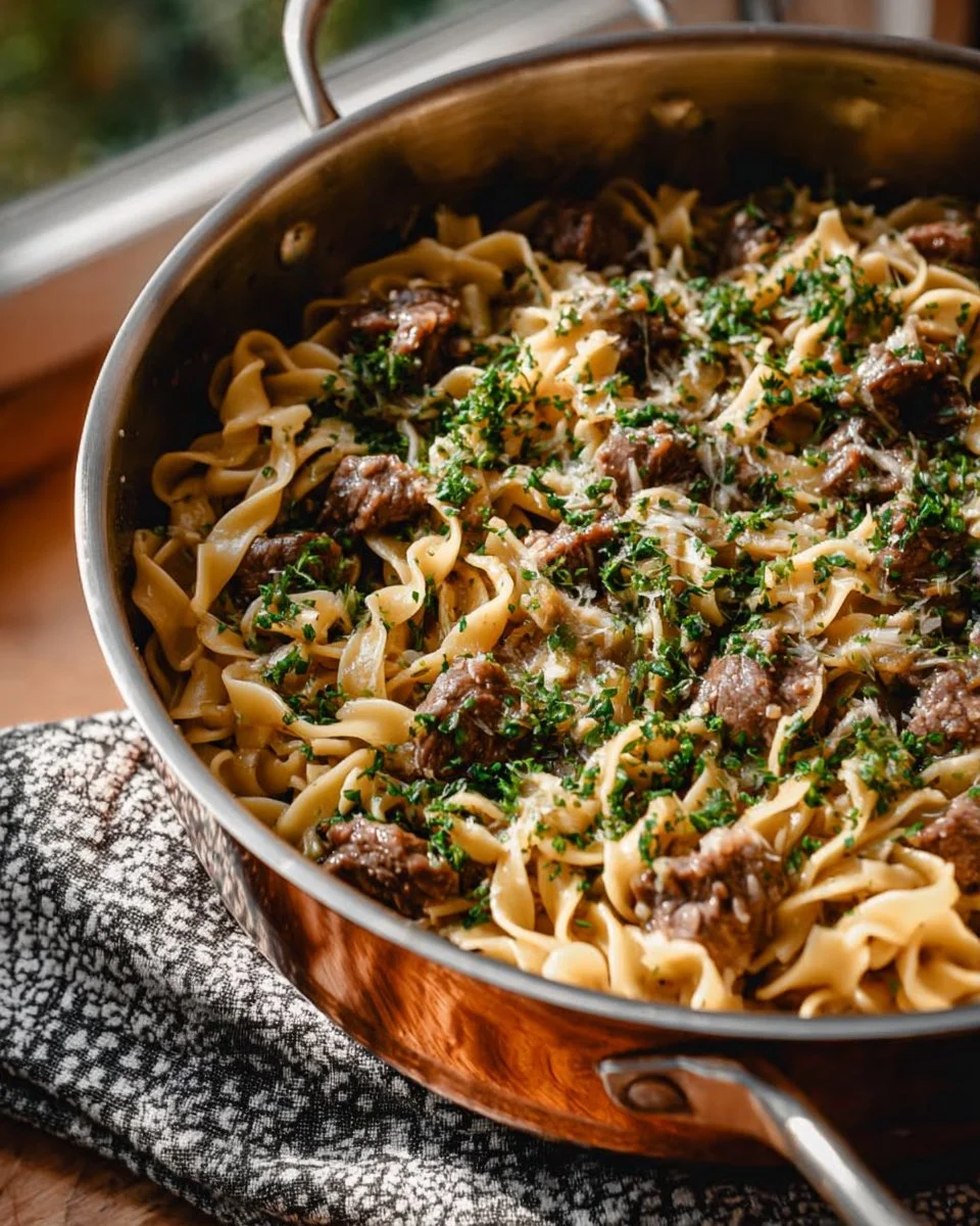 Delicious quick beef stroganoff served with noodles and garnished with parsley