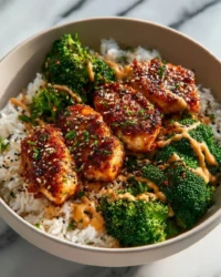 Delicious sticky chicken rice bowls with vibrant vegetables and flavors.