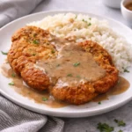 Crispy fried pork chops served with sides for a comforting dinner