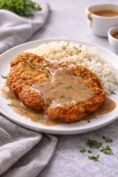 Crispy fried pork chops served with sides for a comforting dinner