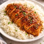 Delicious Honey Garlic Chicken garnished with sesame seeds and herbs