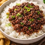 Quick ground beef and rice bowl topped with fresh vegetables.