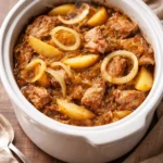 Slow Cooker Pork Loin with Sauerkraut and Apples served on a plate