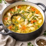 Bowl of ultimate chicken soup with vegetables and herbs