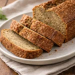 Freshly baked zucchini bread with slices on a wooden board