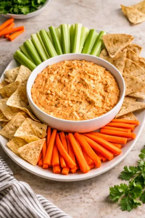 Creamy Buffalo Chicken Dip served with tortilla chips on a table
