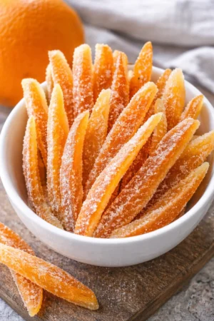 Delicious candied orange peels beautifully presented on a plate.