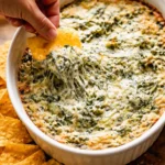 Creamy spinach artichoke dip served in a bowl for appetizers.