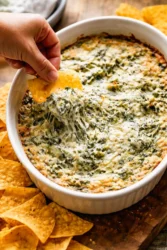 Creamy spinach artichoke dip served in a bowl for appetizers.