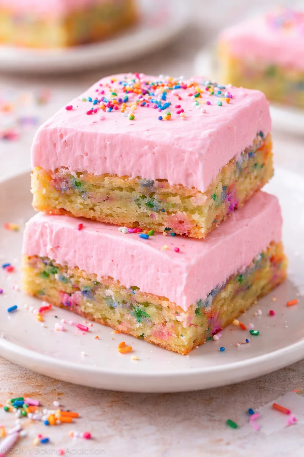 Delicious frosted sugar cookie bars topped with colorful sprinkles.