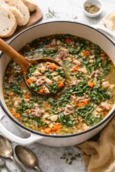 Bowl of hearty ham and bean soup served with fresh herbs