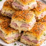 Hot Ham and Cheese Sliders on a plate, perfect for parties or game day.