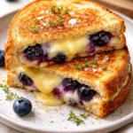 Juicy blueberry grilled cheese sandwich with melted cheese and fresh blueberries