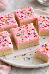Delicious homemade sugar cookie bars topped with colorful sprinkles.