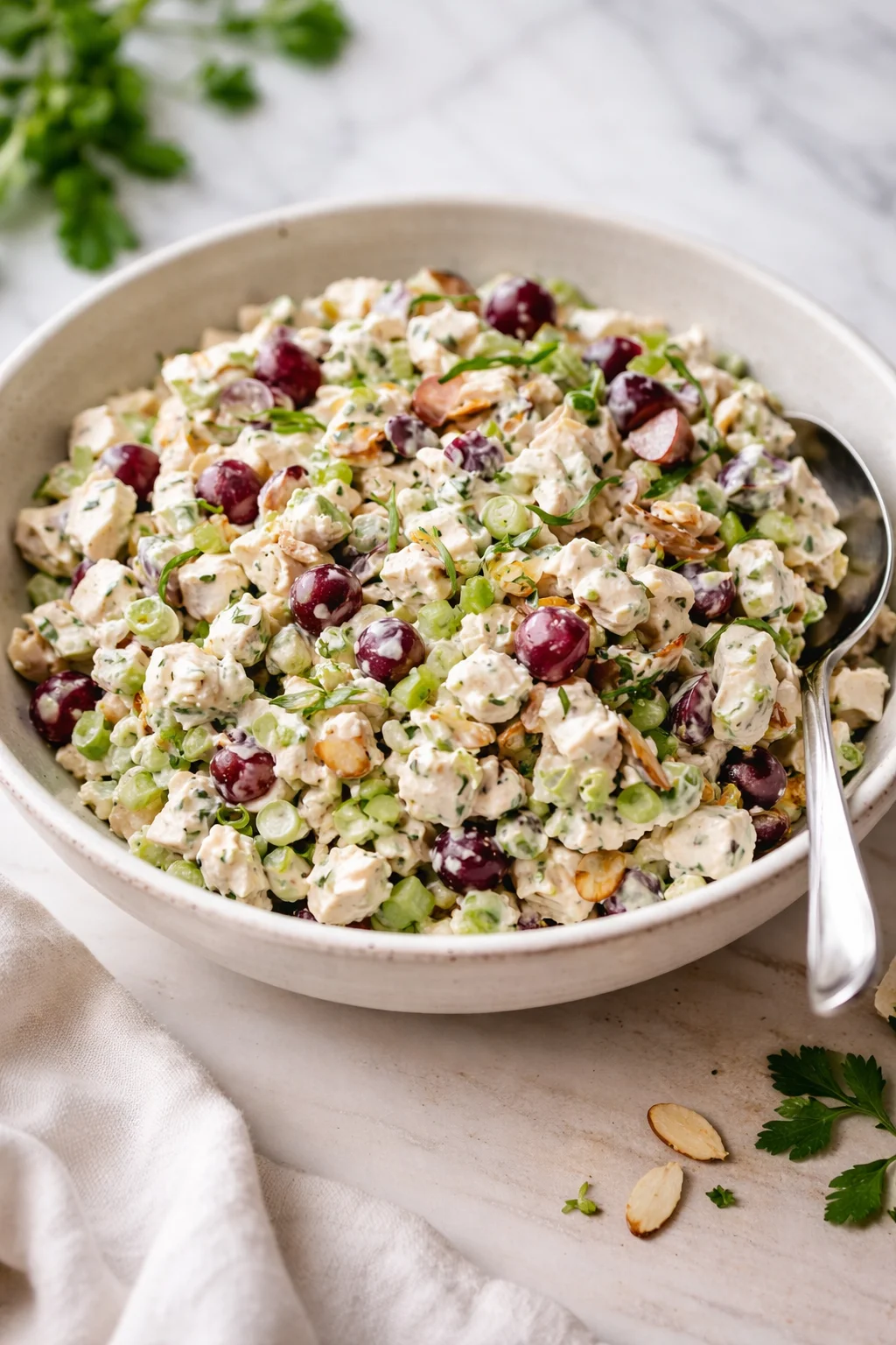 Delicious and fresh chicken salad served in a bowl with greens and vegetables
