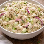 Delicious homemade chicken salad served in a bowl with fresh vegetables