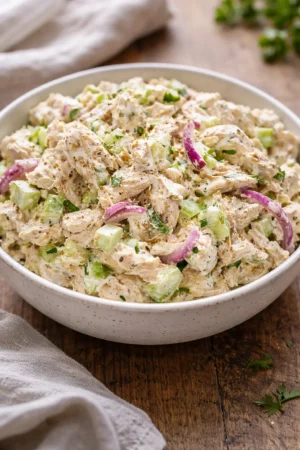 Delicious homemade chicken salad served in a bowl with fresh vegetables