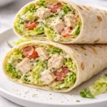 Chopped Chicken Caesar Salad Wraps served on a plate with greens and Caesar dressing