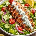 Crispy Greek Tzatziki Chicken Salad with fresh veggies and chicken in a bowl.