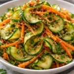 Fresh Cucumber Carrot Salad served in a bowl with dressing
