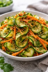 Fresh Cucumber Carrot Salad served in a bowl with dressing