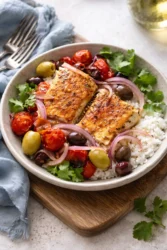 Delicious Mediterranean baked fish with herbs and vegetables ready to serve.