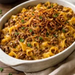 Delicious Family French Onion Hamburger Casserole topped with melted cheese