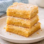 Slice of delicious Gooey Butter Cake on a plate with a fork