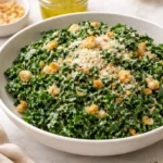 Lemon Parm Kale Salad with fresh ingredients and grated parmesan on a plate
